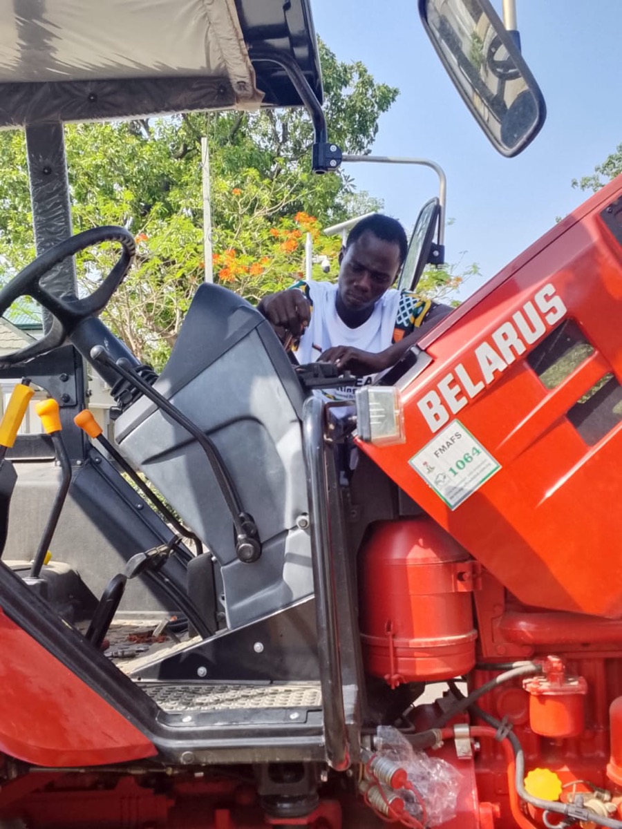 Installing a FarmEASY GPS unit on a tractor in the field